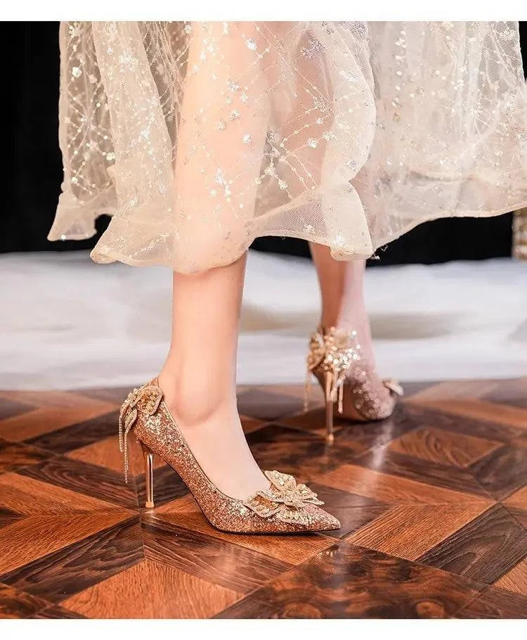 Silver high heels by LYNHURD with pointed toes and bow detail, showcasing a shiny crystal design for women’s casual wear.