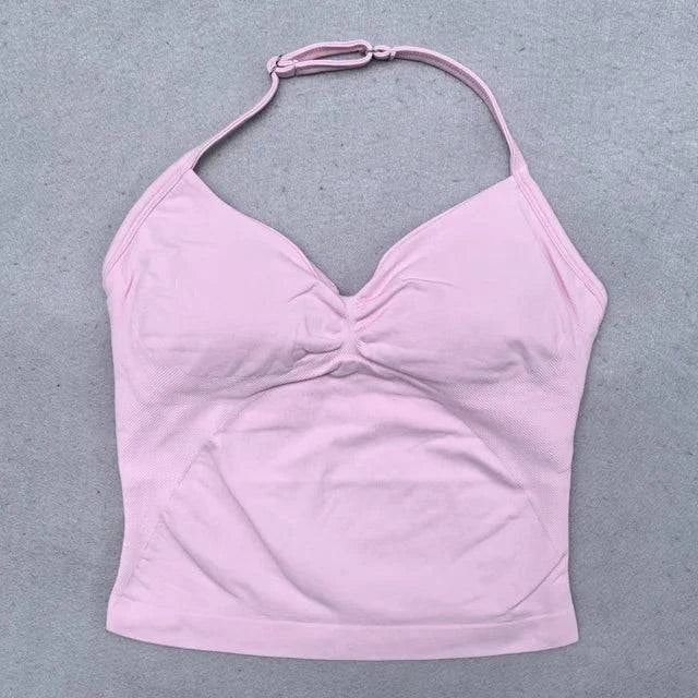 Women’s LYNHURD! yoga set featuring backless halter top and high-waist seamless shorts in a gym setting.
