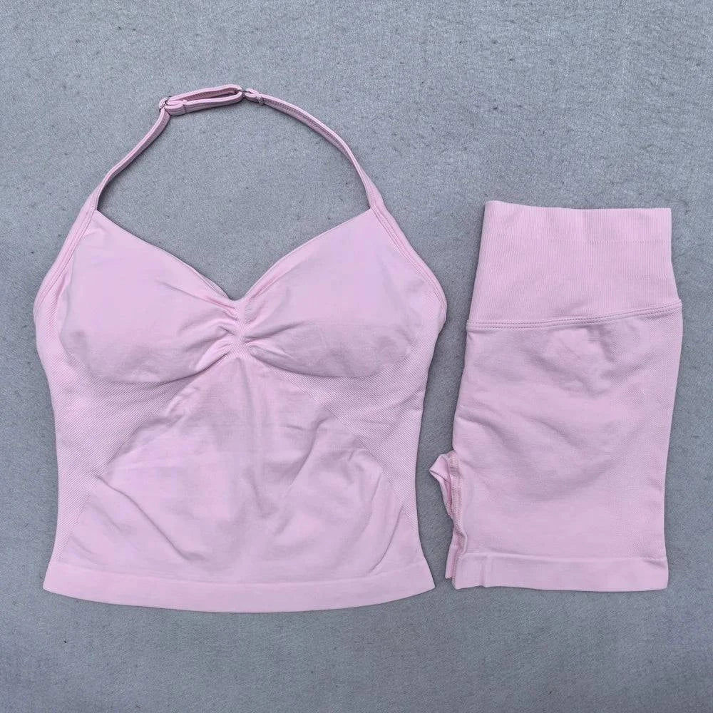 LYNHURD! women's yoga set featuring backless halter top and high waist seamless shorts in a gym setting.