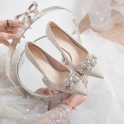 LYNHURD women's wedding shoes with pointed toe, crystal embellishments, and high heels on a rubber sole.