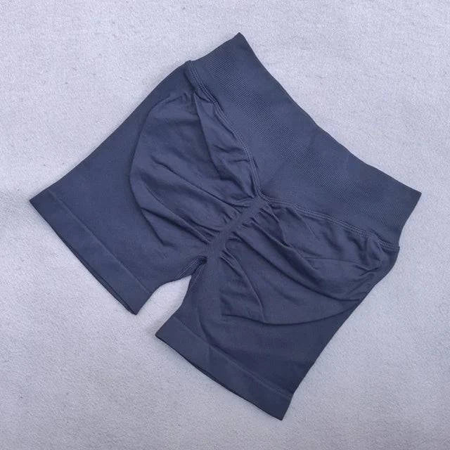 LYNHURD! women's backless halter yoga top and high waist seamless shorts in a fitness gym setting.