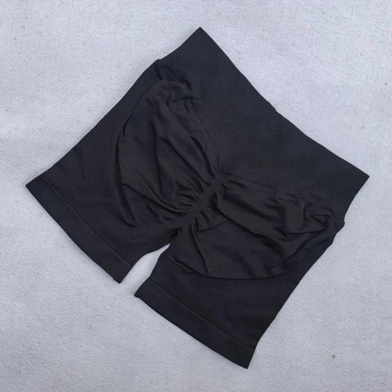 LYNHURD! women's yoga set featuring backless halter top and high waist seamless shorts in a gym setting.