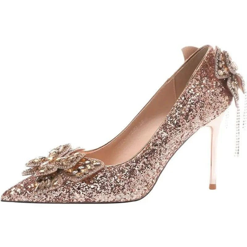 Silver high heels with bow detail, pointed toe design, and crystal embellishments by LYNHURD for women.